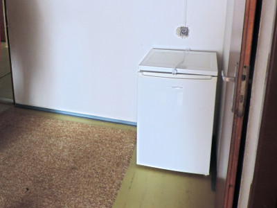 A fridge in the shared space of two rooms